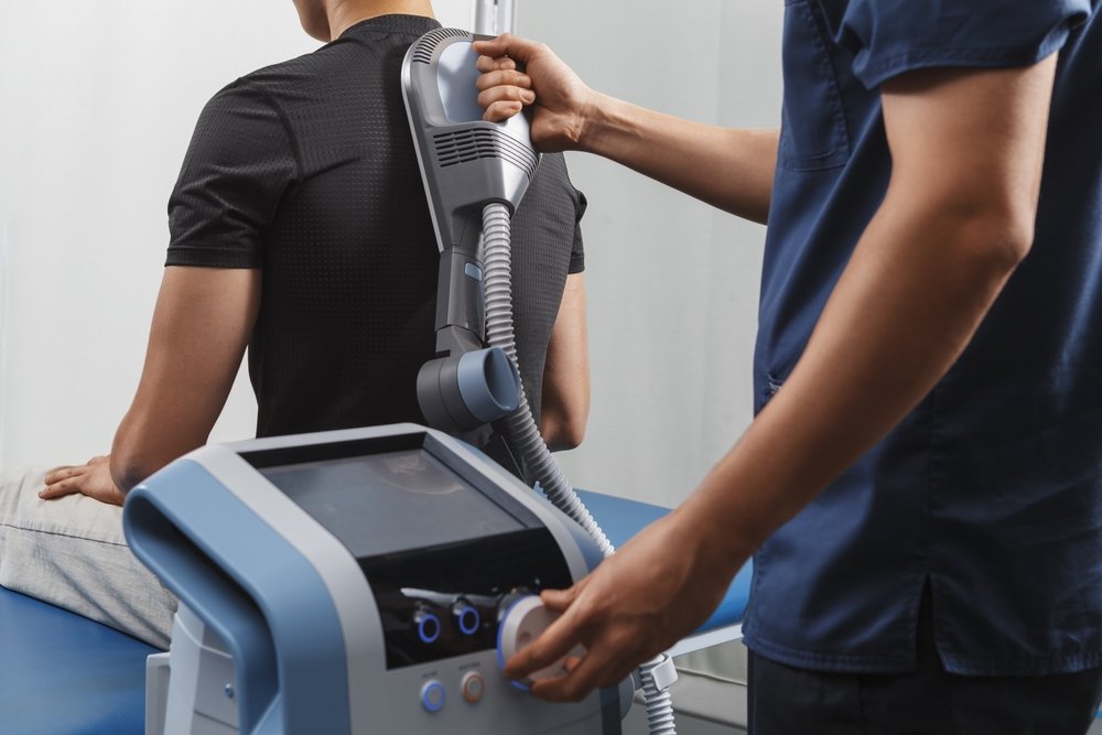 Physiotherapy,Session,With,Electromagnetic,Therapy,Device,Applied,To,Patient's,Back.